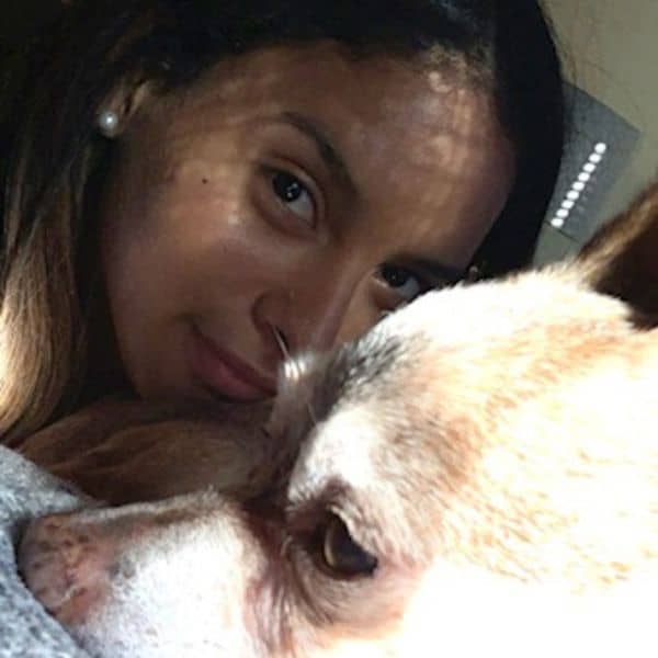 Woman cuddling with her cats, showcasing loving pet care at Lakeside Pet Sitting.