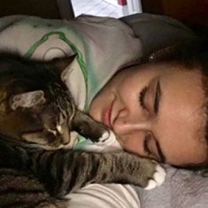 Woman cuddling her cat, showcasing pet care and companionship at Lakeside Pet Sitting.