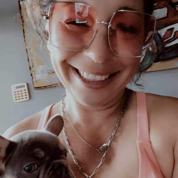 Woman smiling with dog, enjoying pet sitting service at Lakeside Petsitting.